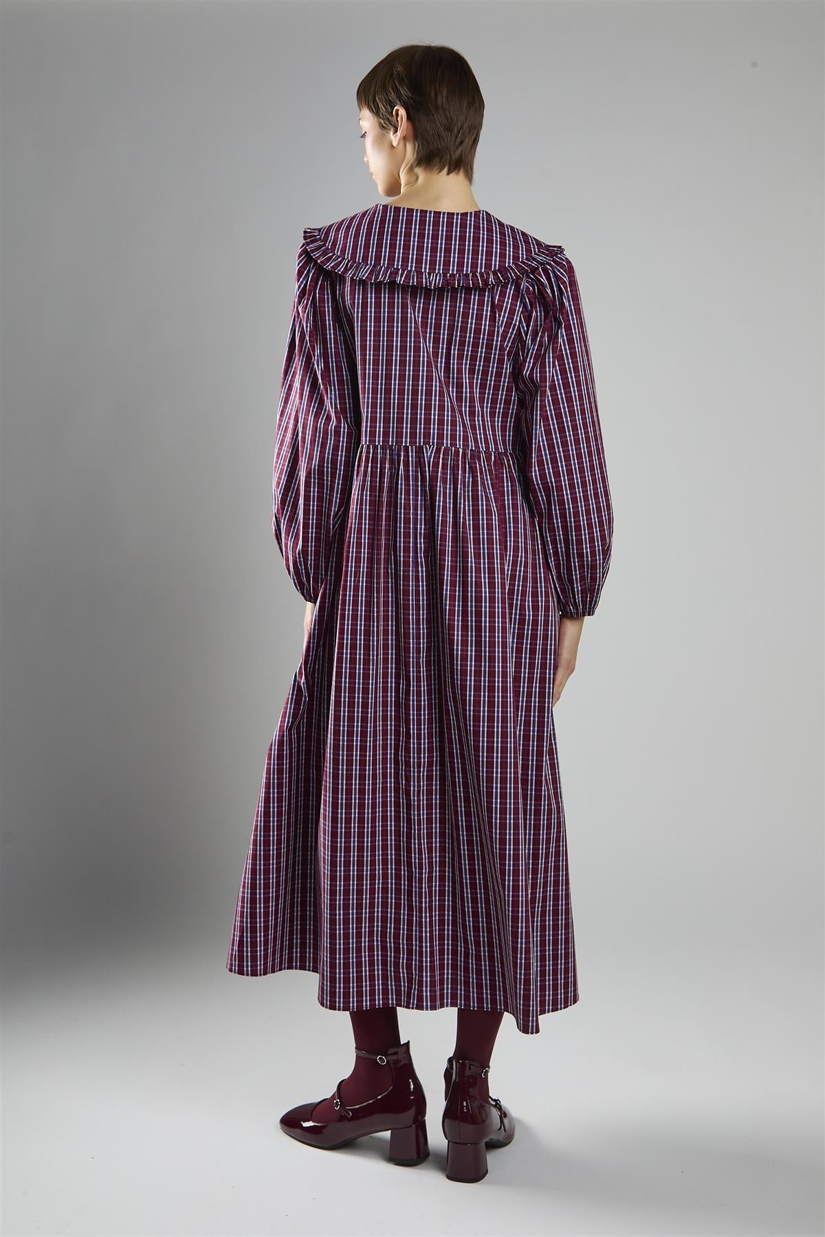 Gothcore long purple checked dress against a grey background Jenna Ortega inspired dress