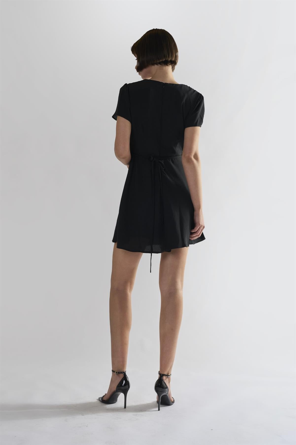 black dress against a white background By Glamorous