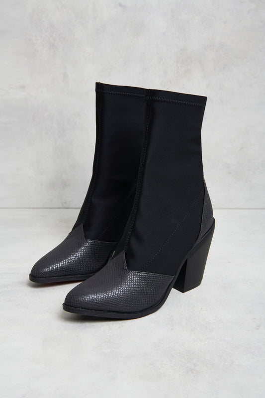 A pair of black western material mix sock boots with a chunky block heel and croc pattern detail.
